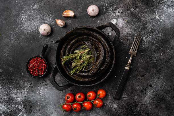 istock Lamprey with herbs, on black wooden table background, top view flat lay 1358747622