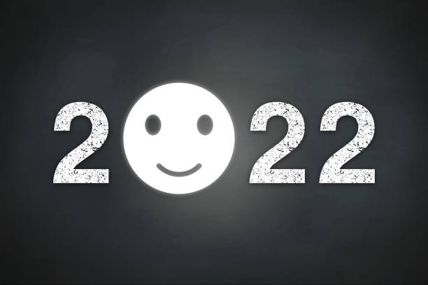 istock Happy New Year 2022 with smile icon on blackboard 1358749311