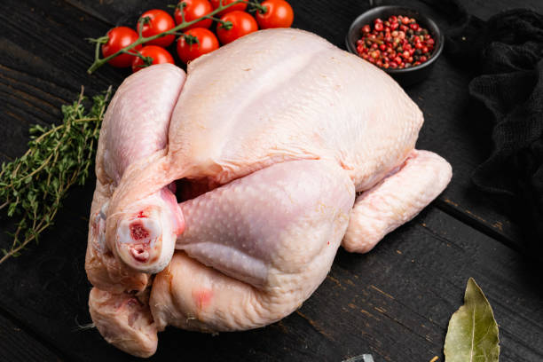 istock Raw chicken, on black wooden table background 1358749705