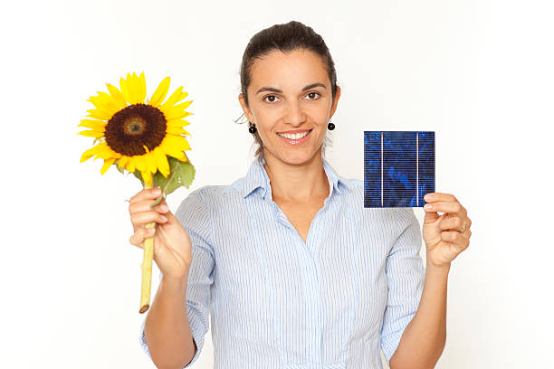Latin solar woman with a sunflower looking in the camera