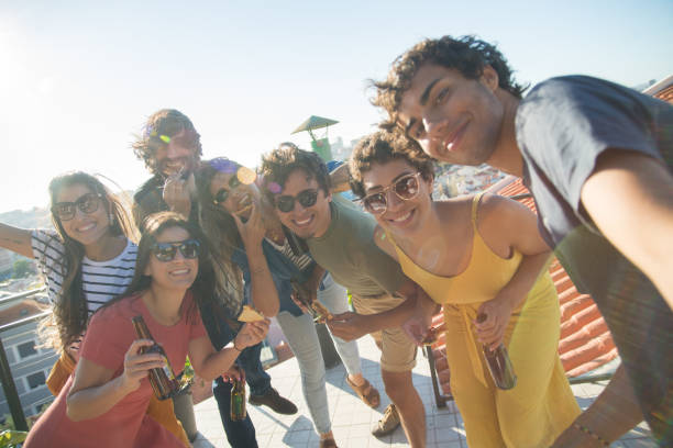 istock Amused friends taking selfie at party 1358752877