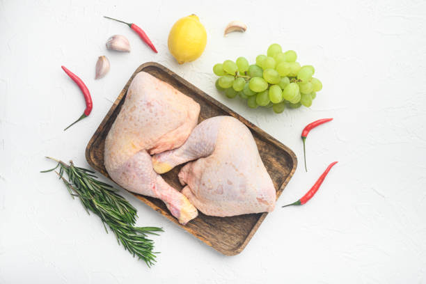 istock Raw organic chicken legs with ingredients for cooking, marinating, on white background, top view flat lay, with copy space for text 1358754817