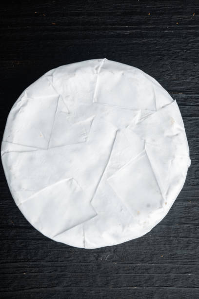 istock French camembert cheese, on black wooden background, top view 1358754940