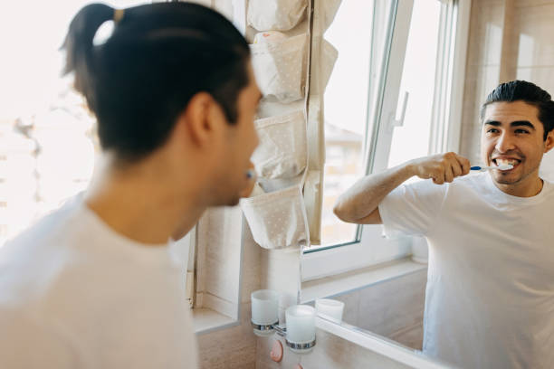 istock Young latin man brushing his teeth 1358755646