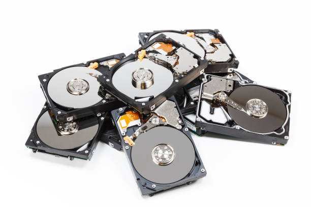 Pile of hard drives with open covers on white background