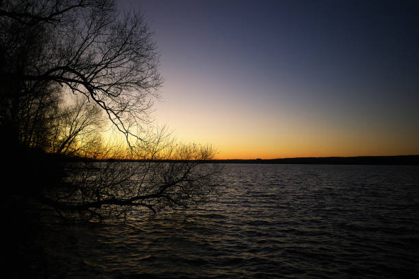 istock Burning sunset at river horizon landscape background 1358757258