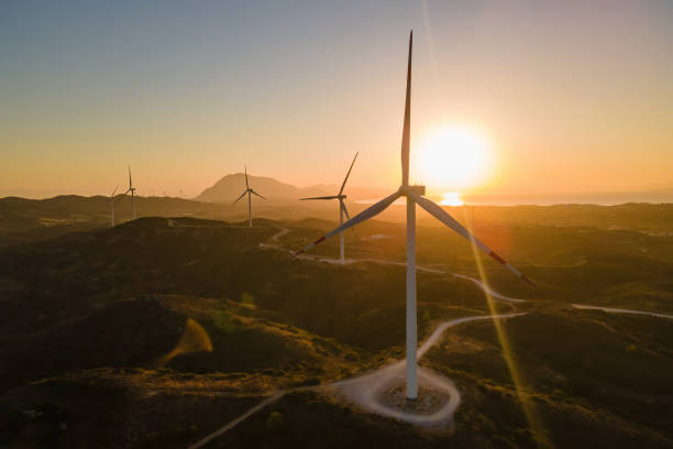Wind farm generating green power with carbon neutral Renewable wind power farm, environmental protection innovation ecosystem electricity generator wind turbines with carbon neutral windmill sunset stock pictures, royalty-free photos & images