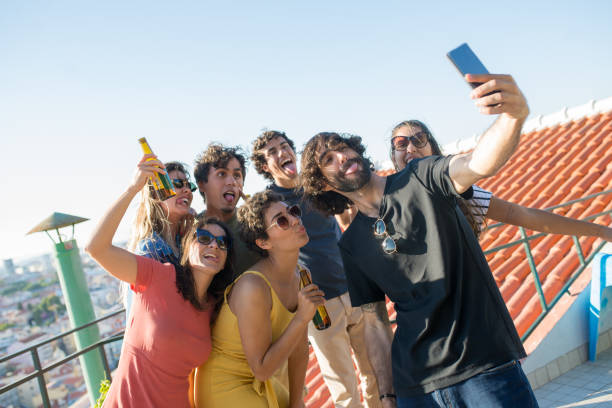 istock Jolly friends taking selfie at party 1358759869