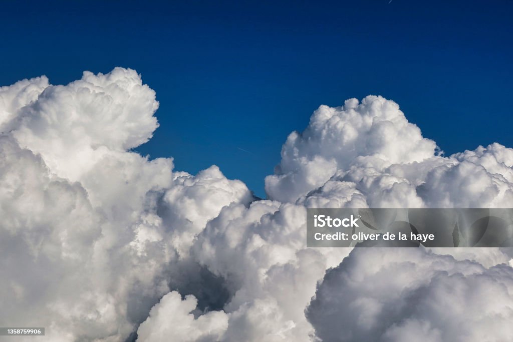 high up aerial view of cloud formations Bellegarde, France - September 6 2021: a field of clouds in the sky visible from a passing air plane Cumulus Cloud Stock Photo