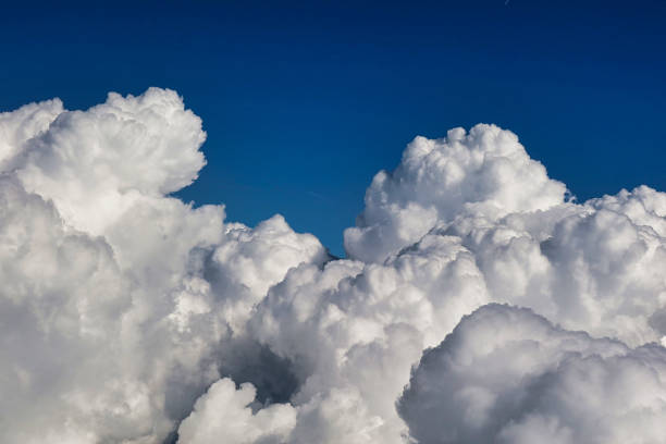 high up aerial view of cloud formations Bellegarde, France - September 6 2021: a field of clouds in the sky visible from a passing air plane cumulus stock pictures, royalty-free photos & images