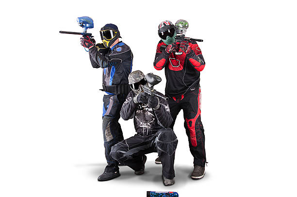 Paint ball player with protective clothing. Paint ball player with face guard hit by two shots.