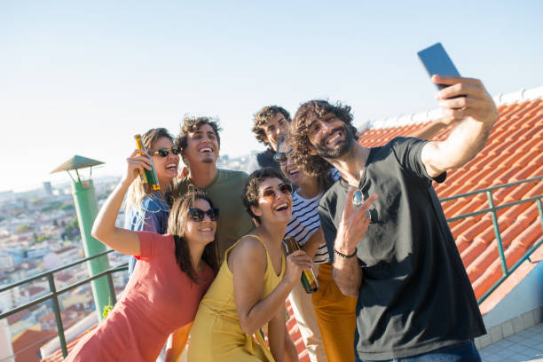 istock Cheerful friends taking selfie at party 1358760377