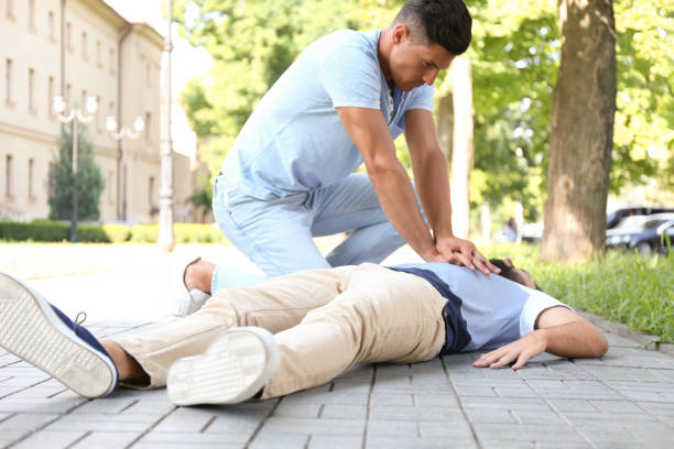 istock Passerby performing CPR on unconscious young man outdoors. First aid 1358761260