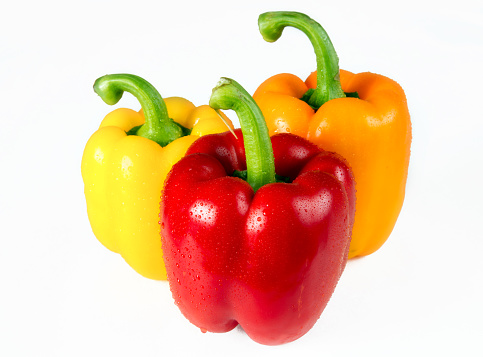 Various Peppers with Pepper Leaves on white Background