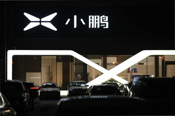 Shanghai.China-Dec.11th 2021: XPeng Motors‘s sales store and service center at night. XPeng's brand logo. A Chinese electric vehicle manufacturer.