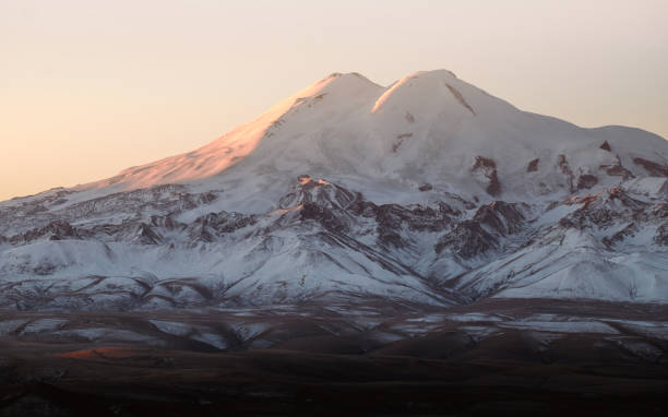 Photography of the mountain Elbrus in autumn Beautiful photography of the snowy mountain Elbrus. Autumn weather, nature travel in Russia. Sunny outdoor scenics. winter sunrise mountain snow stock pictures, royalty-free photos & images