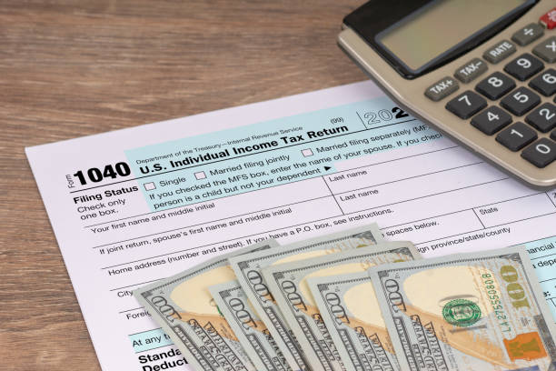 istock tax return application form with dollar banknotes and calculator 1358763248