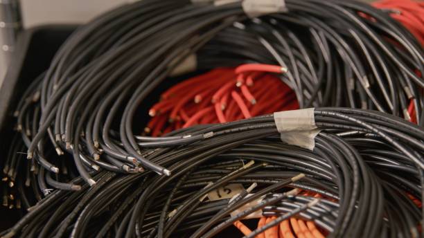 istock Heap of rolled up red and black cables front view 1358763312