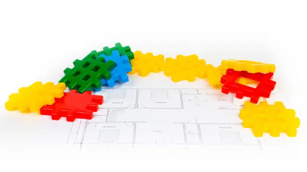 new house paper project plan with plastic toy blocks heap