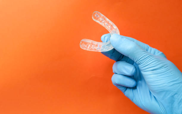 doctor holding a dental retainer or dental splint stock photo