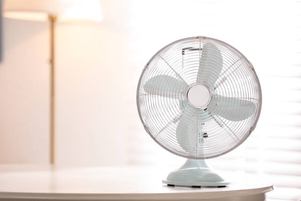 istock Modern electric fan on white table indoors. Space for text 1358763681