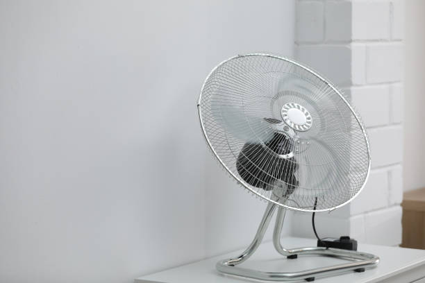 istock Modern electric fan on white table indoors. Space for text 1358763714
