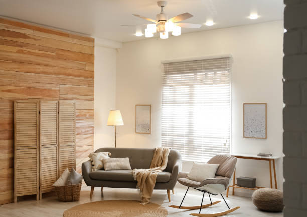 istock Stylish living room interior with modern ceiling fan and comfortable sofa 1358764007
