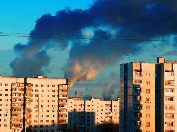 istock Industrial smoke over city suburbs architecture 1358764061