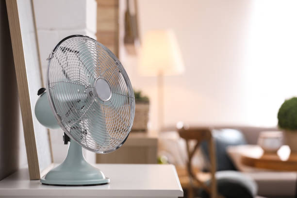 istock Modern electric fan on white table indoors. Space for text 1358764139