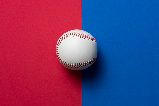baseball on red and blue table background, top view sport concept