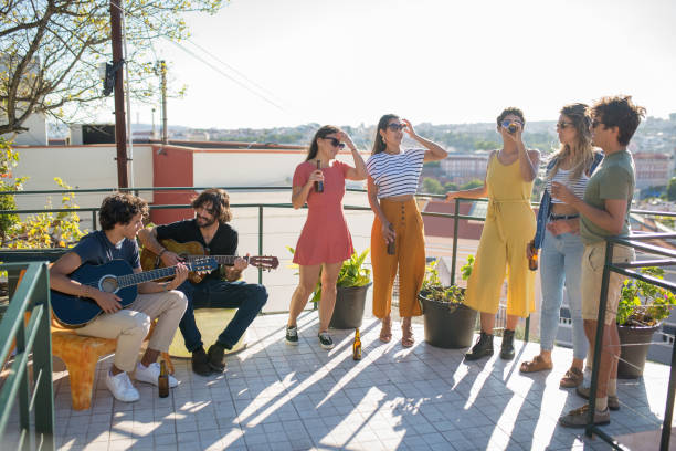 istock Happy friends at party on sunny day 1358764719
