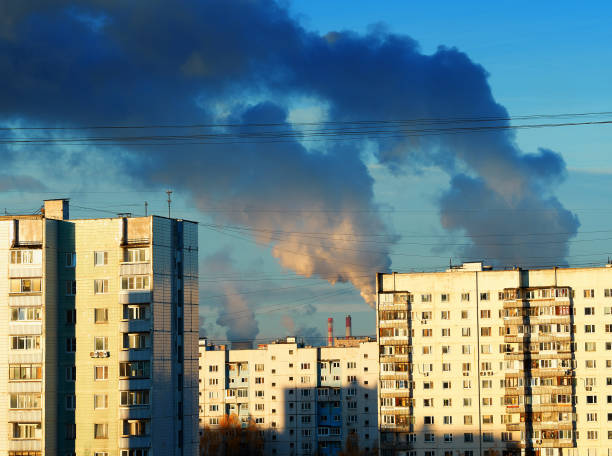 istock Industrial smoke over city suburbs architecture 1358765060