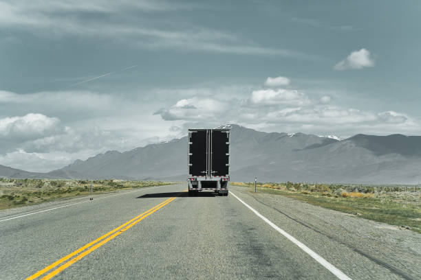 istock Commercial truck on a highway. View from behind. 1358765344