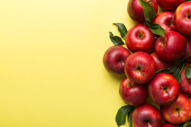 istock Many red apples on colored background, top view. Autumn pattern with fresh apple above view with copy space for design or text 1358765493