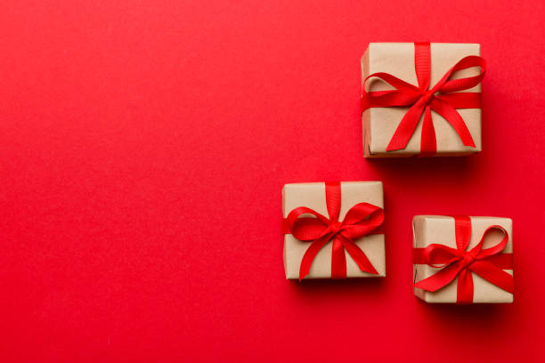 istock Valentine day composition: red gift box with bow and heart. Christmas present. View from above. Space for text. Holday greeting card 1358765548