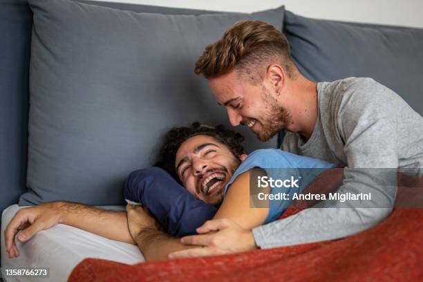 Happy Male Gay Couple On Bed At Home Couple Of Smiling Married Men Just Woke Up In The Morning Coming Out From The Closet Concept Stock Photo - Download Image Now