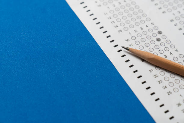 istock close up pencil on answer sheets on blue table background, education concept 1358766528