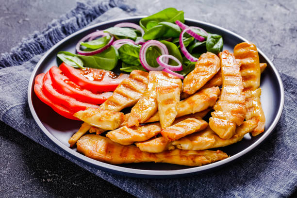 istock grilled chicken strips on a plate with vegetables 1358768244