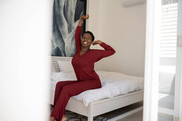 istock Black African woman stretching on bed, morning routine, new day and start 1358768351