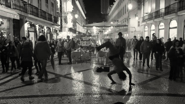 Lisbon, Portugal - December 19, 2015: A young man oerforms hip-hop dancing at the Rua Augusta street in Lisbon downtown.