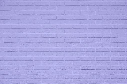 very peri brick wall texture. copy space. lavender blue background