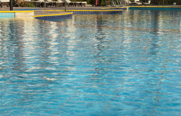 istock selective focus on the blue surface of the water in the pool with reflections. 1358771037