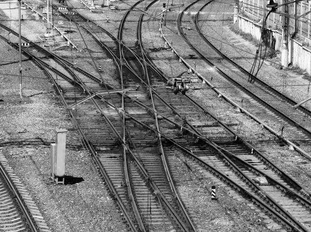 istock Black & white railway crossroads transportation 1358771139