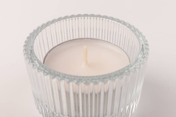 istock Tea candles in a glass candlestick, isolated on white. Space for text 1358771156
