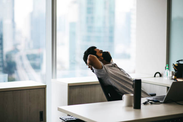 istock Businessman relaxing at desk in office 1358773689