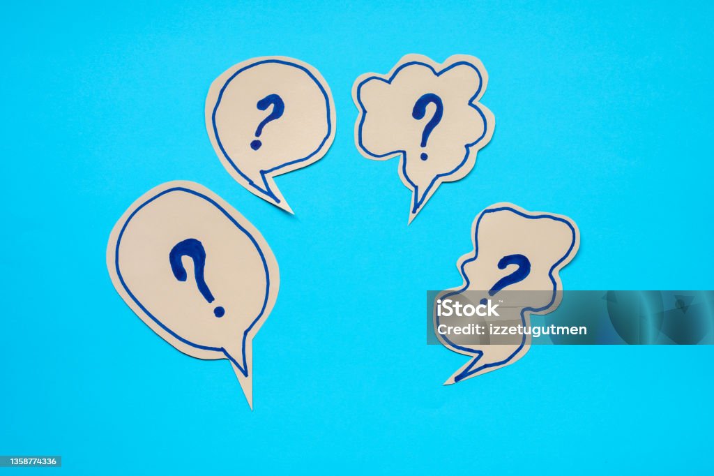 questions in speech bubble over blue background Ignorance Stock Photo