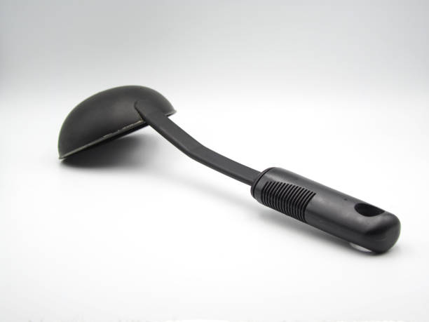 istock Black plastic soup ladle on white background 1358777242