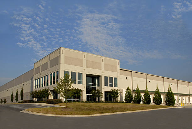 istock Brown and tan distribution center with green trees in front 135877733