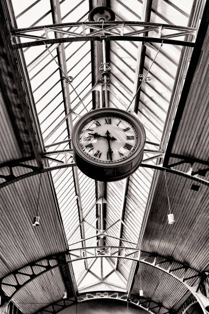 istock Black and white concept of a vintage public clock 1358778211