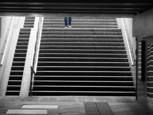 istock Legs and foots on city stairs background 1358778308